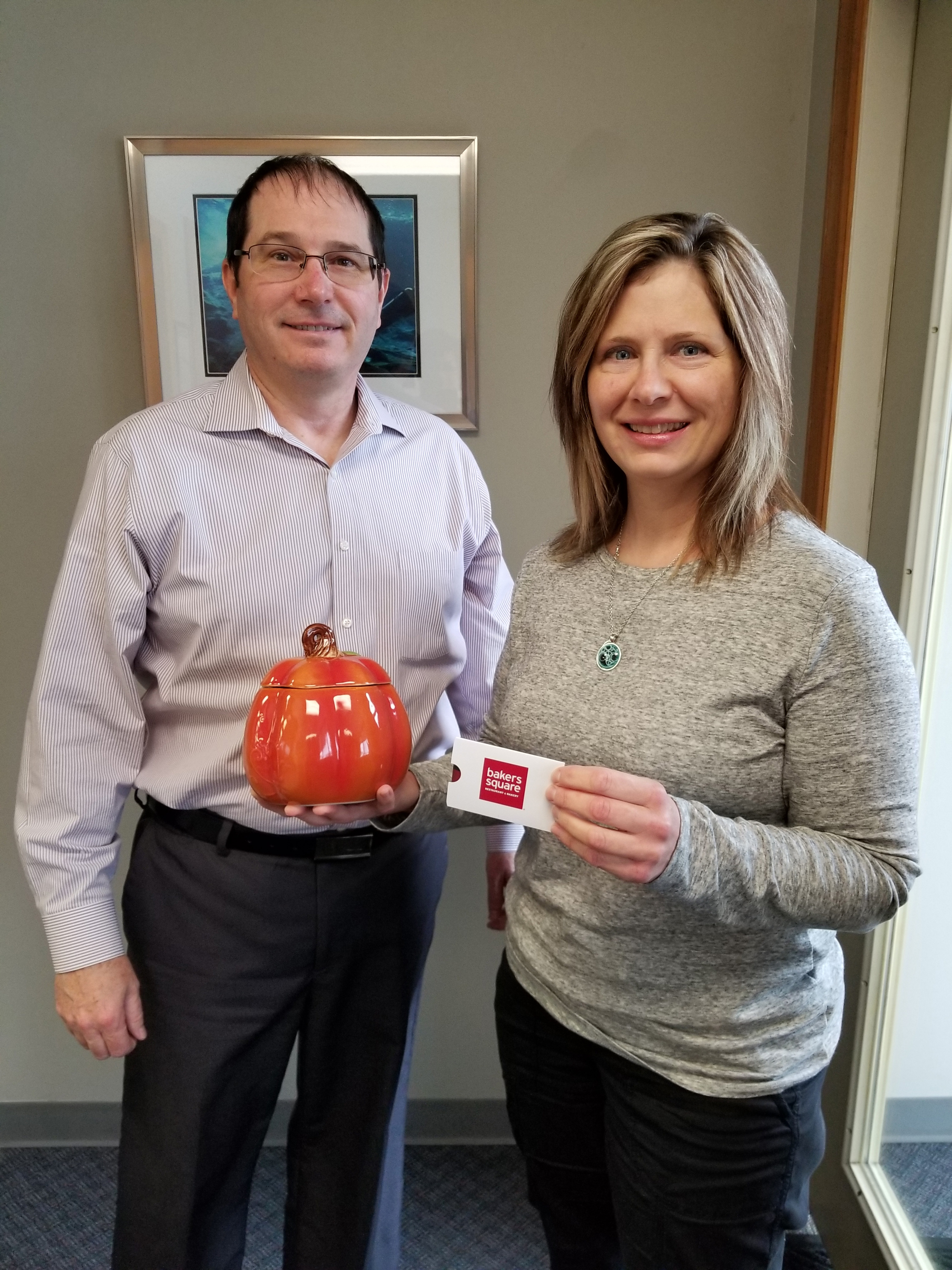 Picture of Dr. Michael Gordon and a patient after winning a contest in our Schereville dental office.