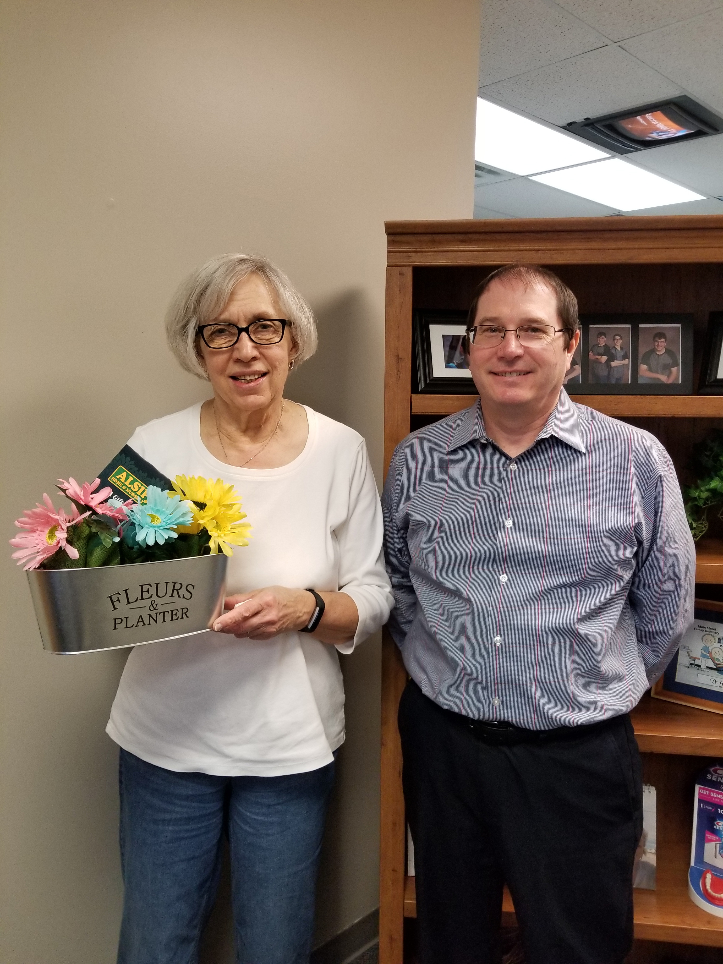 Dr. Michael Gordon and a patient after winning a contest in our Schereville dental office.